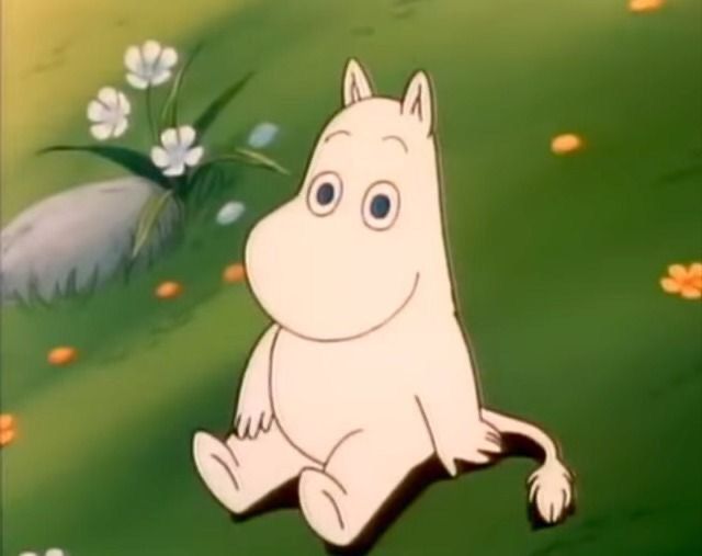 moomin sitting in a field